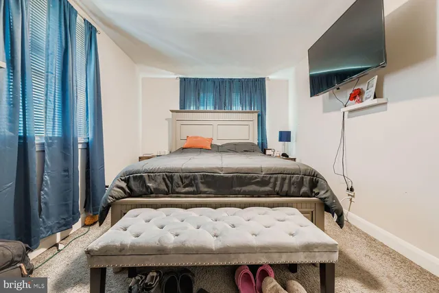 a bedroom with a bed and window