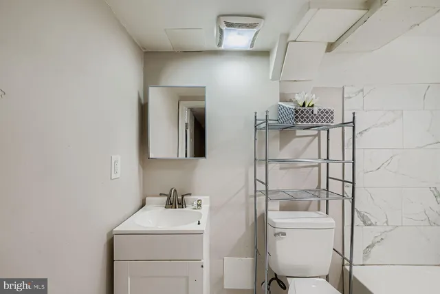 a bathroom with a sink toilet and vanity