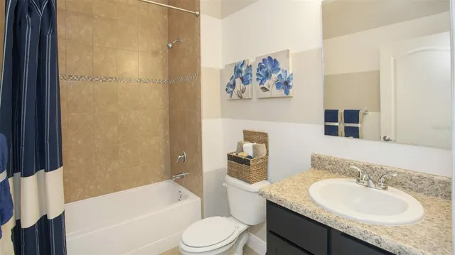a bathroom with a granite countertop sink toilet and a bathtub