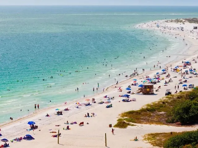 a front view of a house with a flower garden