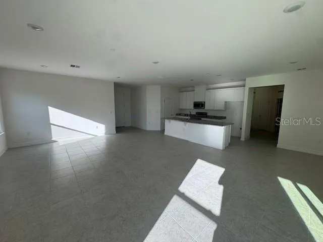 a kitchen with stainless steel appliances granite countertop a refrigerator a stove and a sink