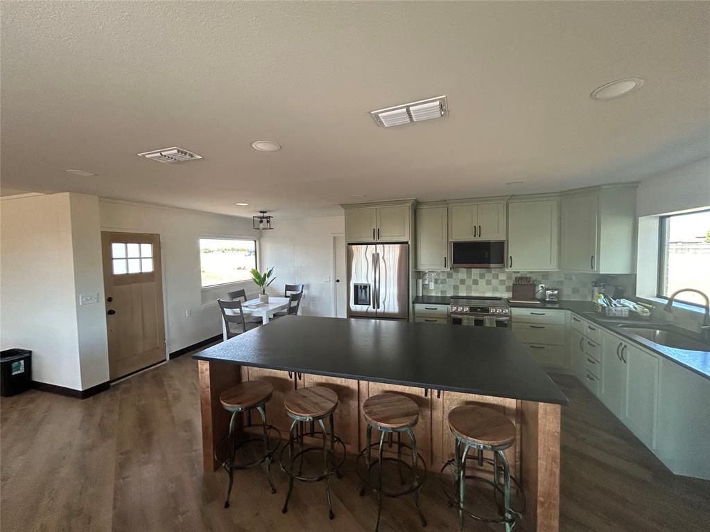 5400 Ridgeline Drive Abilene, TX 79606 - Photo 1 of 33 a kitchen with a dining table chairs and refrigerator