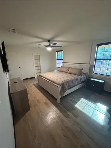 a bedroom with bed and window