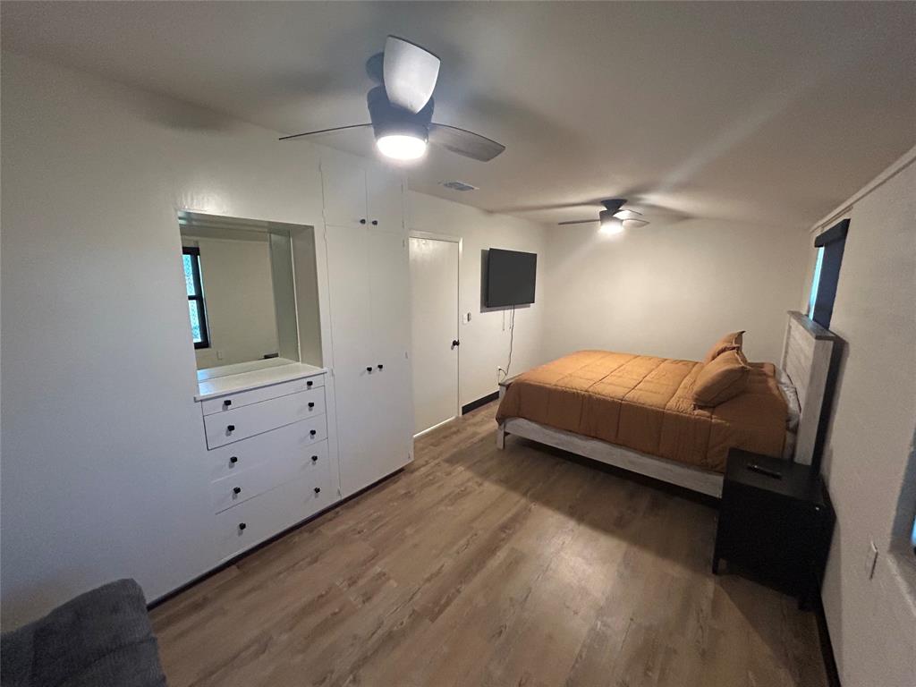 5400 Ridgeline Drive Abilene, TX 79606 - Photo 16 of 33 a bedroom with a bed and a chandelier