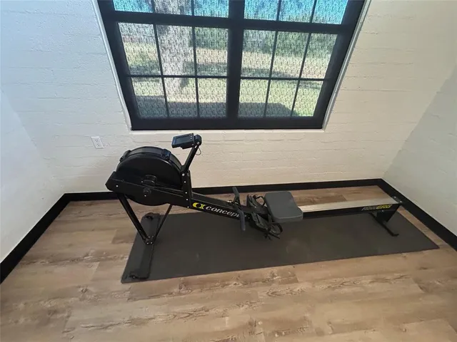 a bedroom with a bed window and a flat screen tv