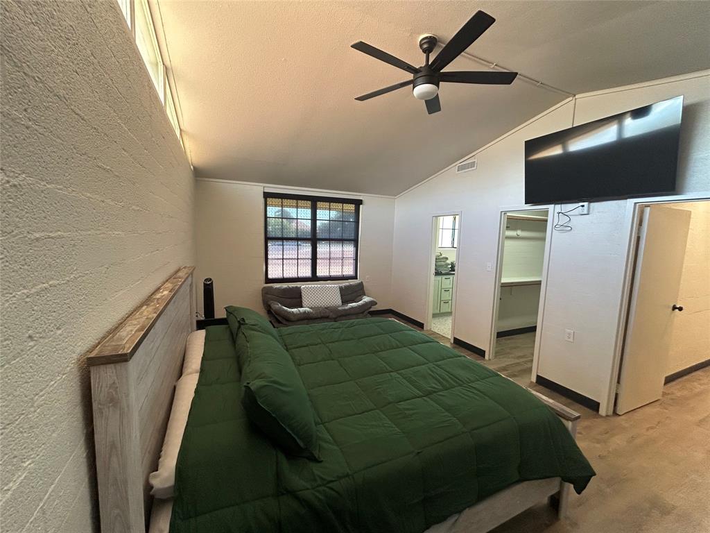 5400 Ridgeline Drive Abilene, TX 79606 - Photo 21 of 33 a bedroom with a bed window and a flat screen tv