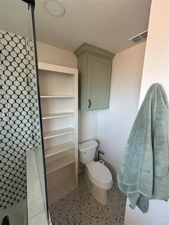 5400 Ridgeline Drive Abilene, TX 79606 - Photo 24 of 33 a bathroom with a toilet and a shower