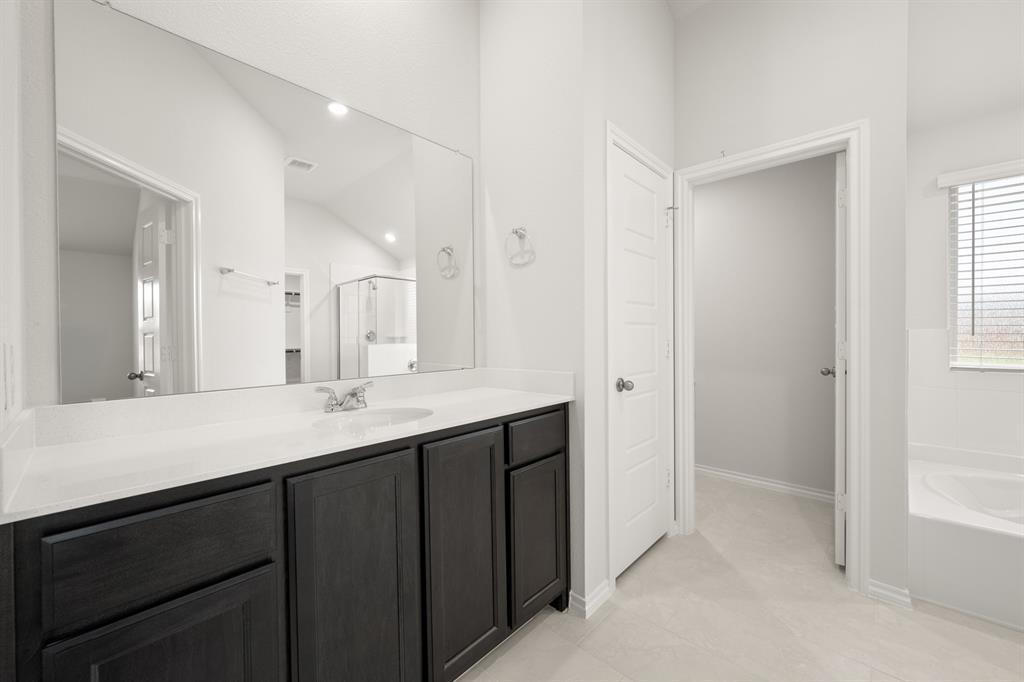 2607 Streamside Drive Burleson, TX 76028 - Photo 19 of 27 a kitchen with a sink and a mirror
