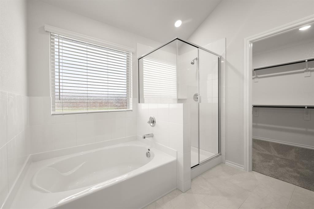 2607 Streamside Drive Burleson, TX 76028 - Photo 20 of 27 a bathroom with a bathtub and a shower
