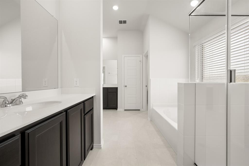 2607 Streamside Drive Burleson, TX 76028 - Photo 23 of 27 a bathroom with a double vanity sink and mirror