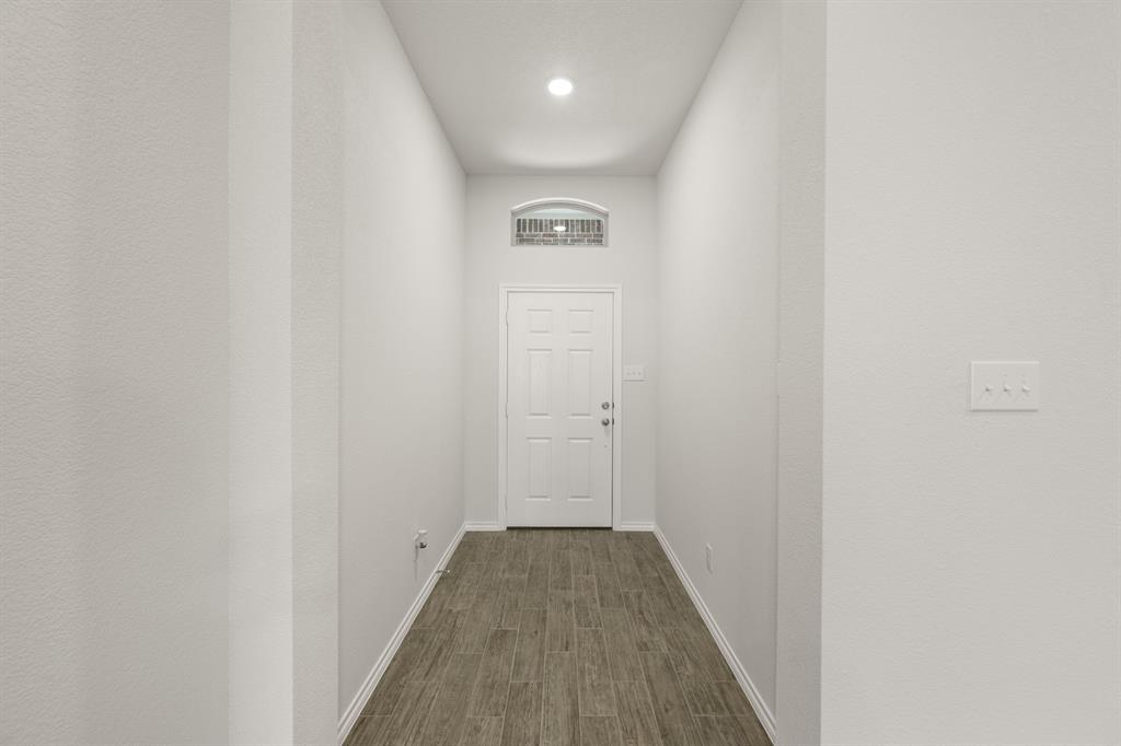 2607 Streamside Drive Burleson, TX 76028 - Photo 3 of 27 a view of a hallway with wooden floor