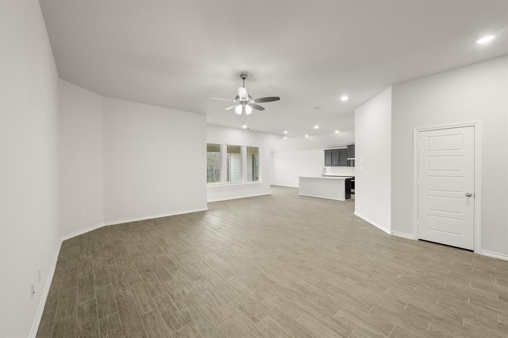 2607 Streamside Drive Burleson, TX 76028 - Photo 8 of 27 a view of an empty room with a kitchen