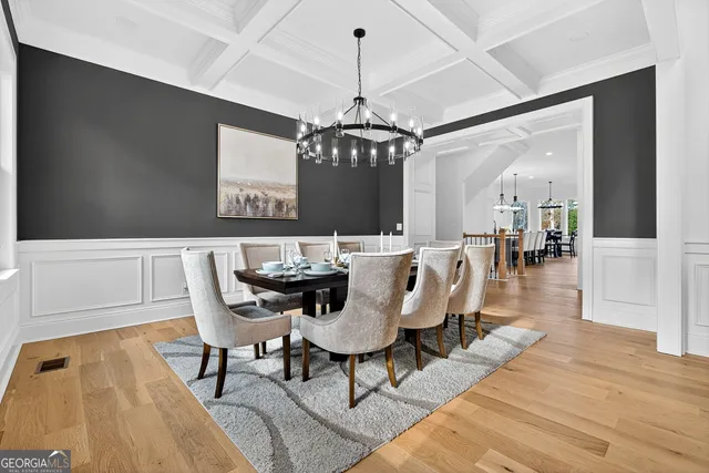 a dining room with furniture window and wooden floor