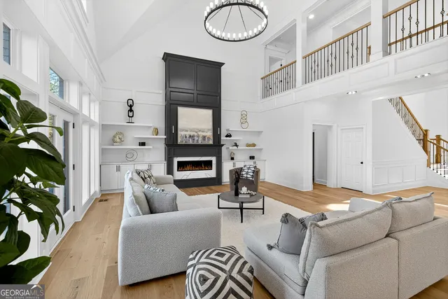 a spacious bathroom with a granite countertop sink a toilet a mirror and shower