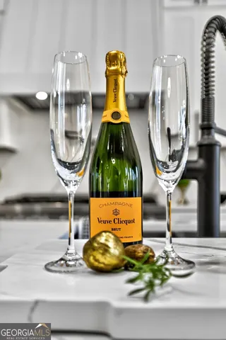 a kitchen with a dining table chairs and cabinets