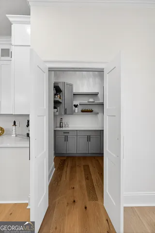a kitchen with refrigerator cabinets dining table and chairs