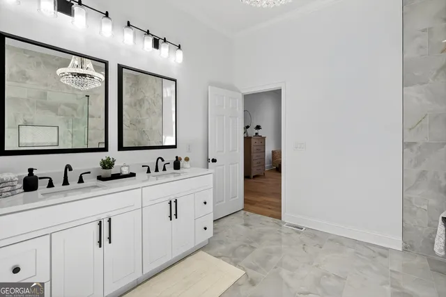 a front view of a house with yard and trees around