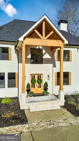 a dining room with a wooden table and chairs