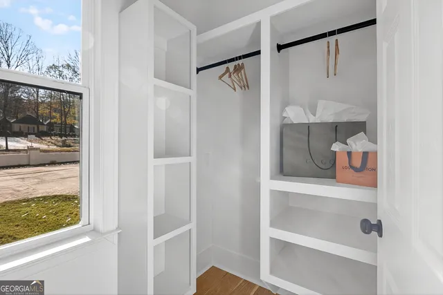 a view of a house with a big yard and large trees