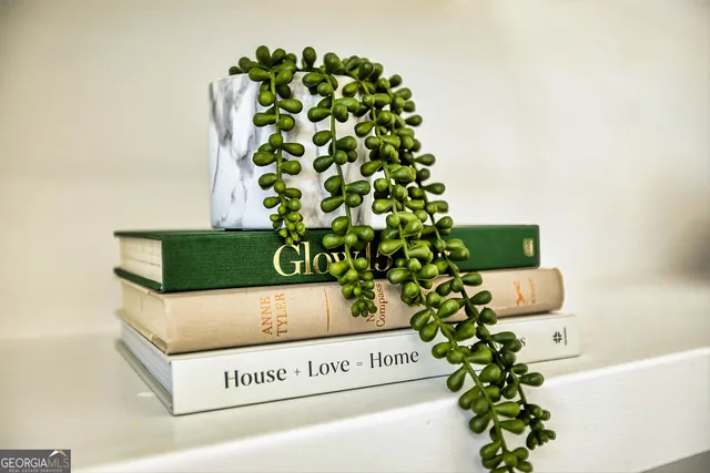 a kitchen with white cabinets and wooden floor