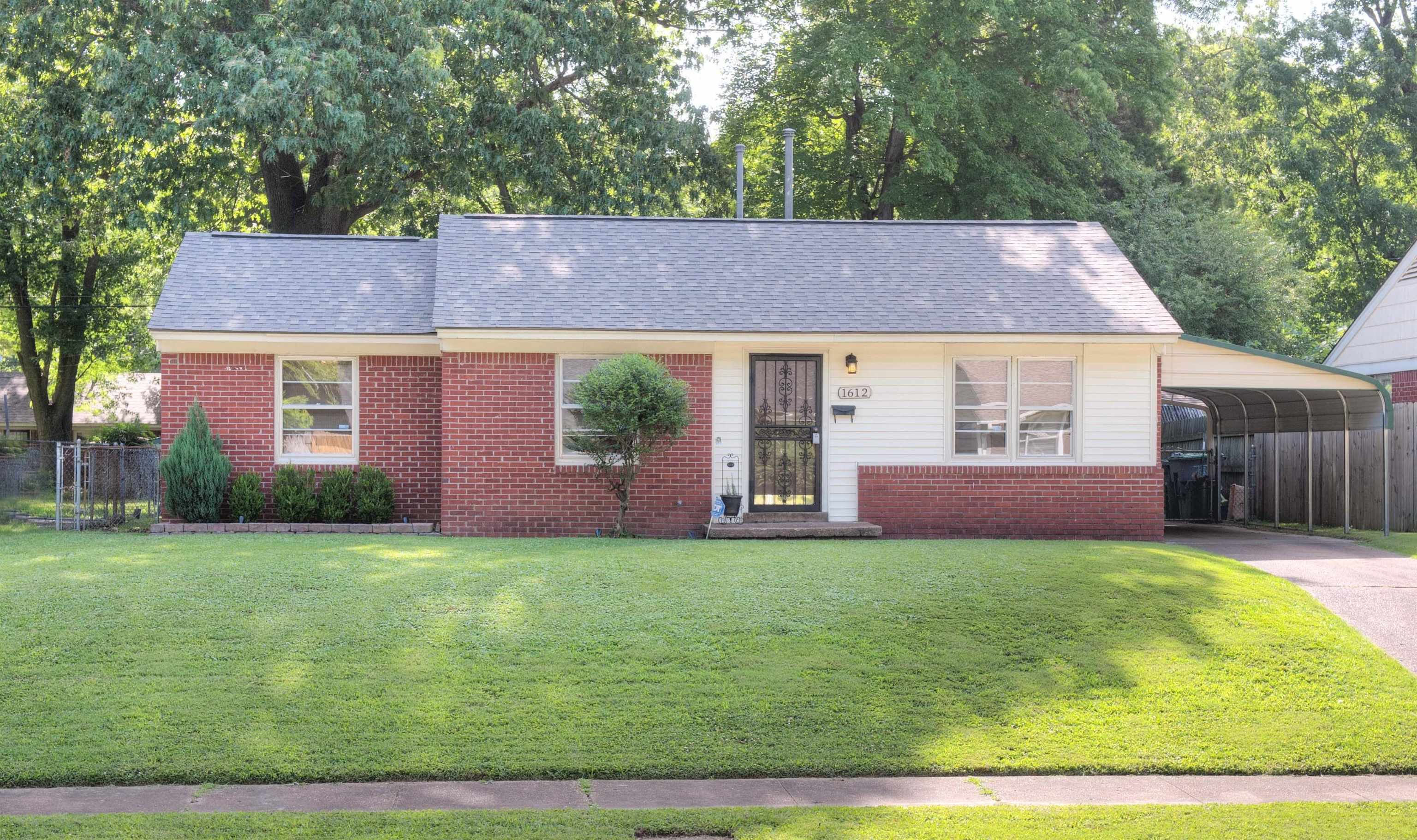 1612 Raymore Road Memphis, TN 38117 - Photo 1 of 17 a front view of a house with a yard