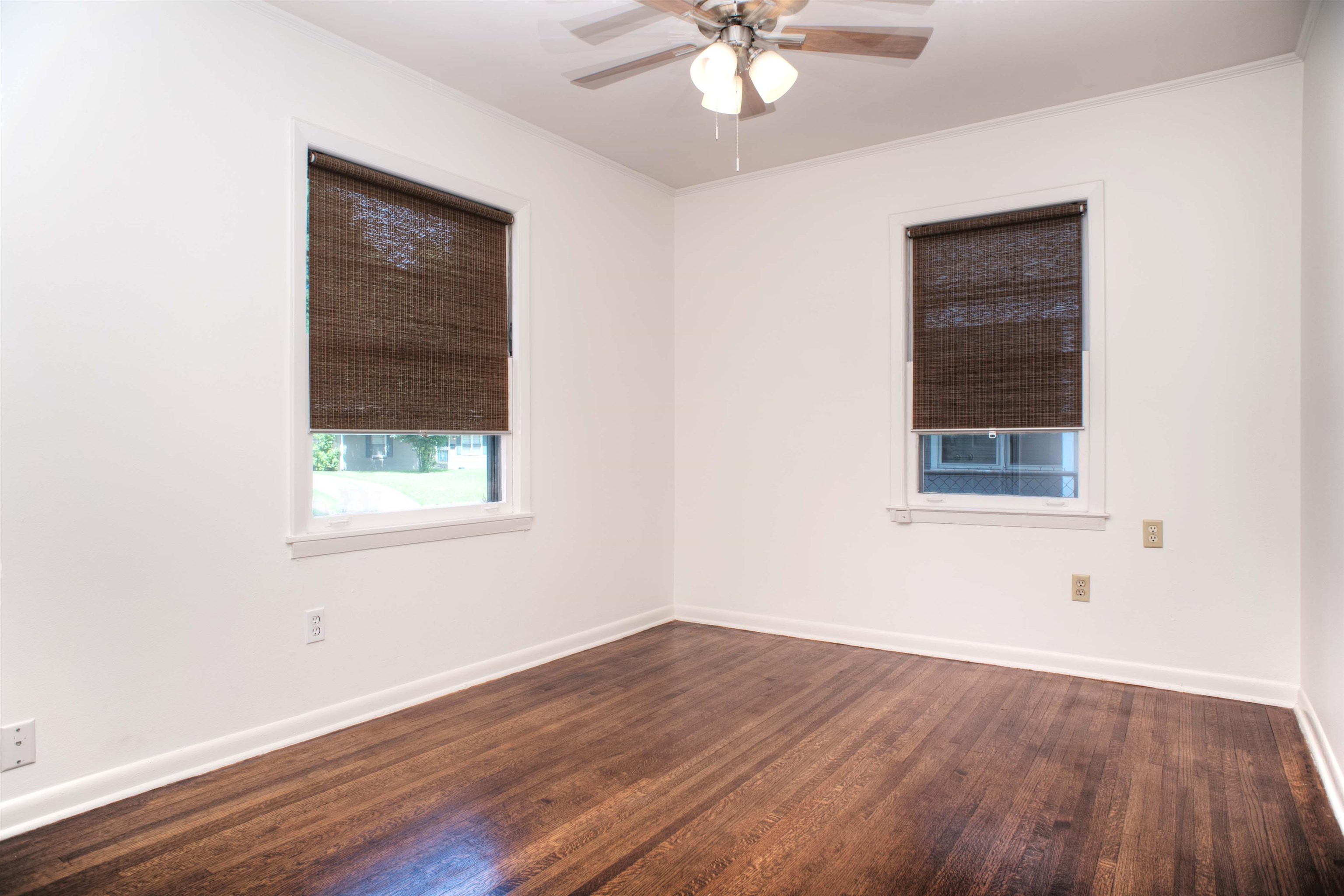 1612 Raymore Road Memphis, TN 38117 - Photo 11 of 17 a view of an empty room with wooden floor and a window