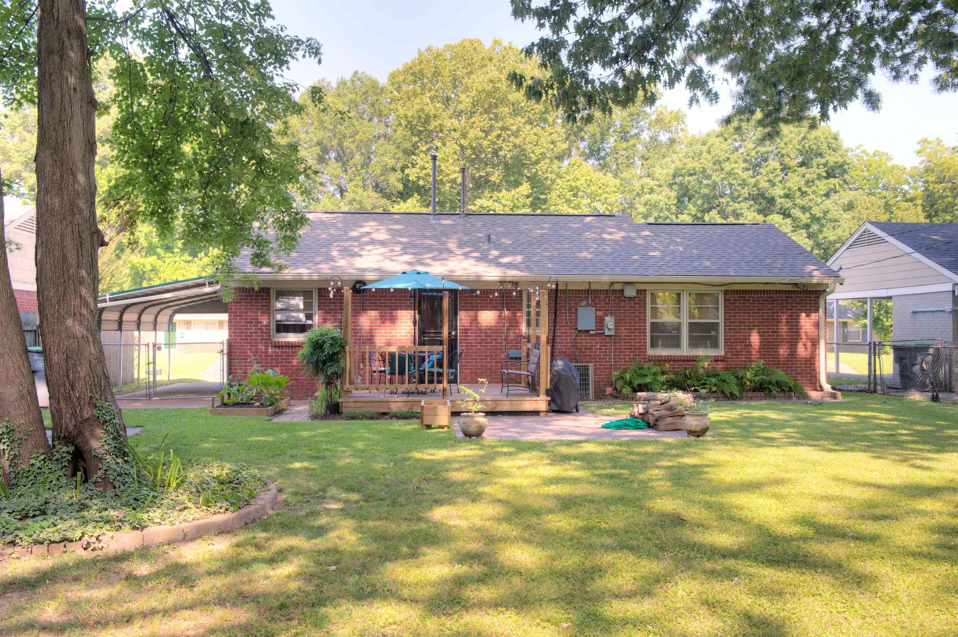 1612 Raymore Road Memphis, TN 38117 - Photo 17 of 17 a front view of a house with a yard table and chairs
