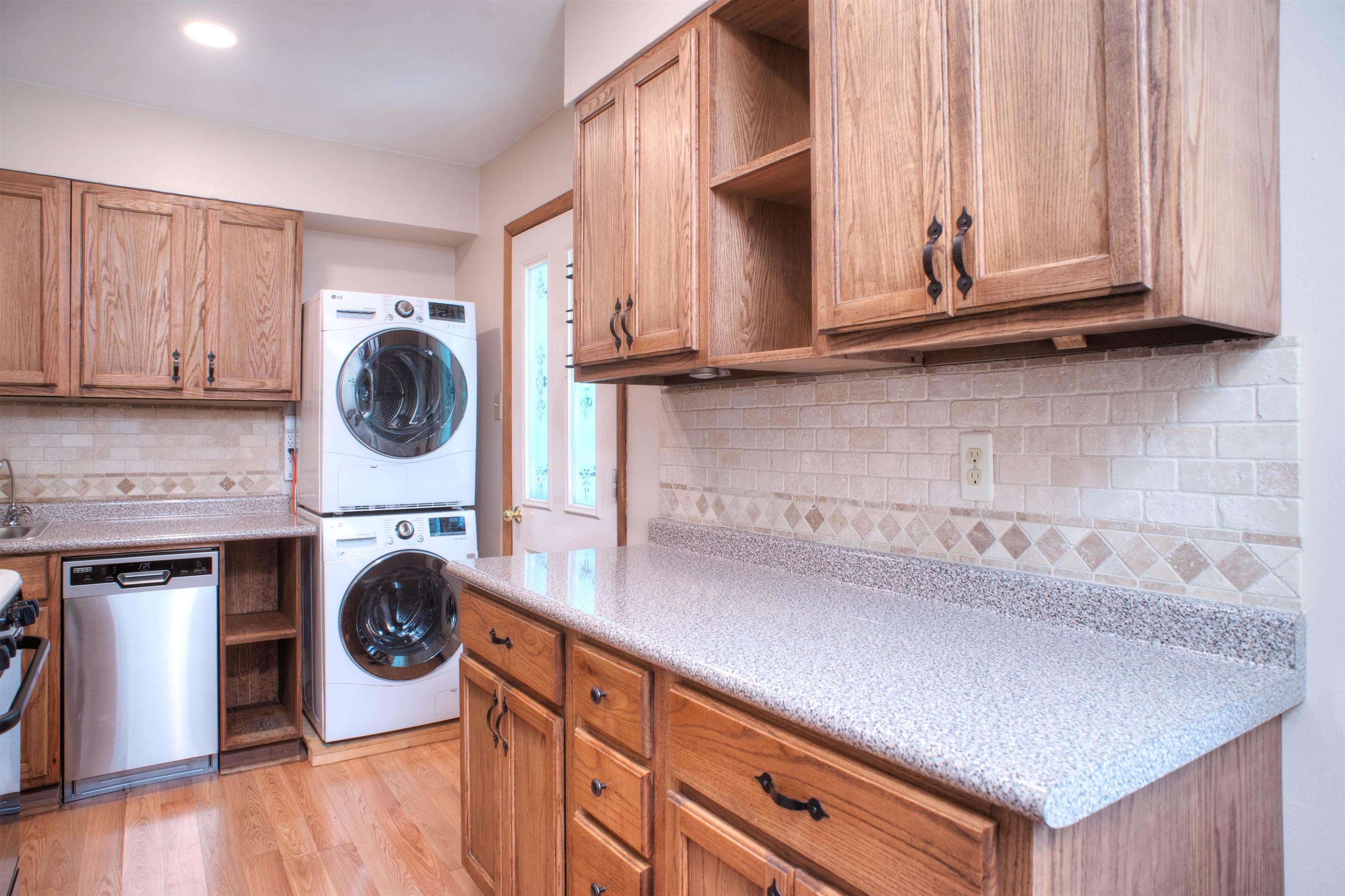 1612 Raymore Road Memphis, TN 38117 - Photo 6 of 17 a kitchen with a stove a washer and dryer