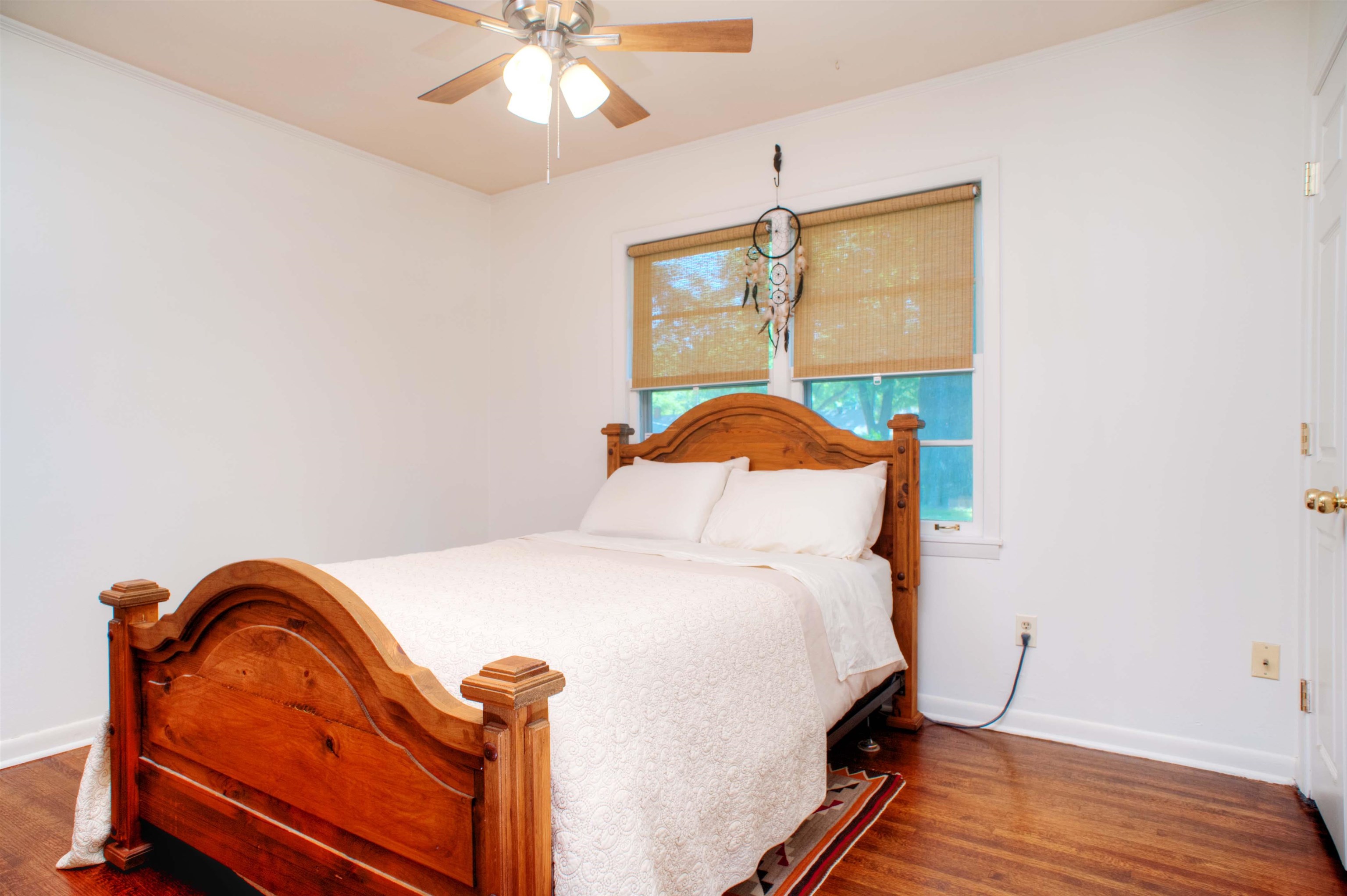 1612 Raymore Road Memphis, TN 38117 - Photo 8 of 17 a bedroom with a bed and wooden floor