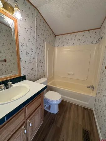 a view of walk in closet with wooden floor