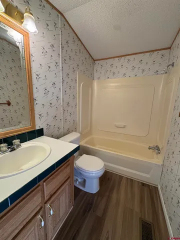 a view of walk in closet with wooden floor