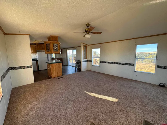 a view of a kitchen with furniture and a ceiling fan