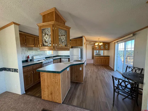 a kitchen with stainless steel appliances granite countertop a refrigerator a sink and a stove