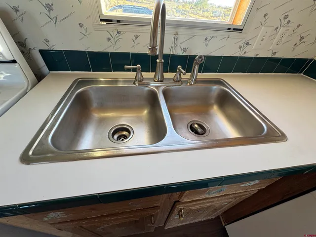 a kitchen with stainless steel appliances granite countertop a sink a microwave cabinets and wooden floor