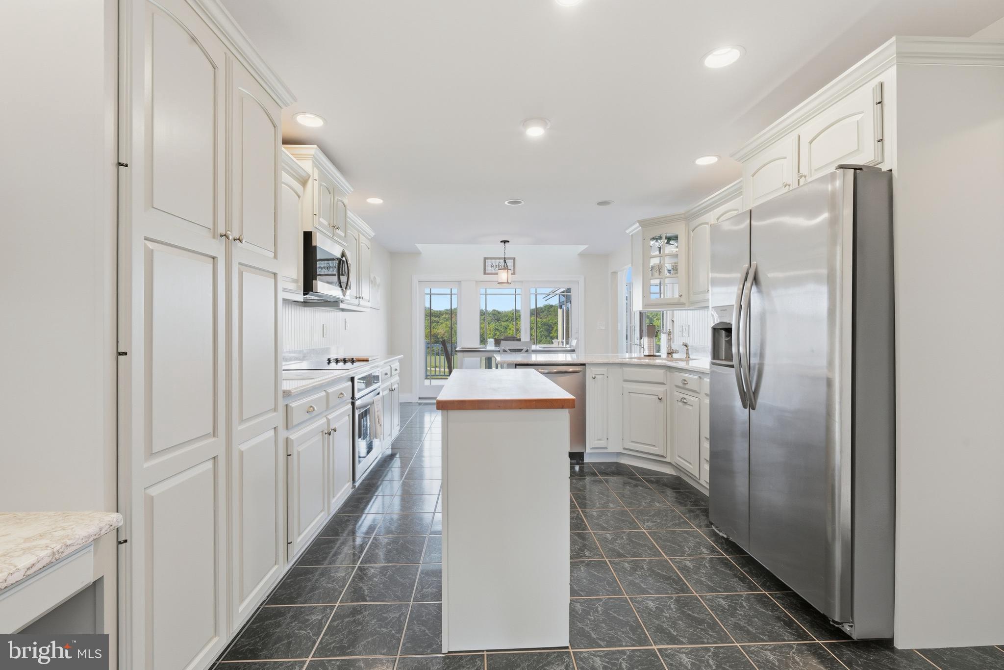 115 Scott Road Warwick, MD 21912 - Photo 12 of 32 a kitchen with white cabinets and refrigerator