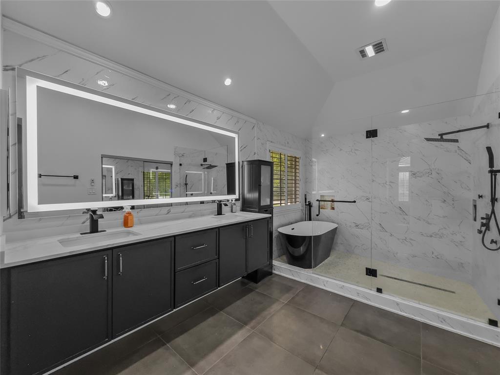 2317 Wellesly Road Rowlett, TX 75089 - Photo 18 of 39 a bathroom with a double vanity sink toilet and shower