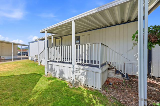 150 West 7500th South, Unit 55 Midvale, UT 84047 - Photo 28 of 28 Covered porch with white railings and exterior stairs