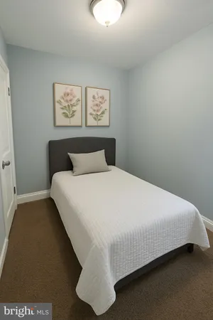 a bedroom with a bed and a night stand