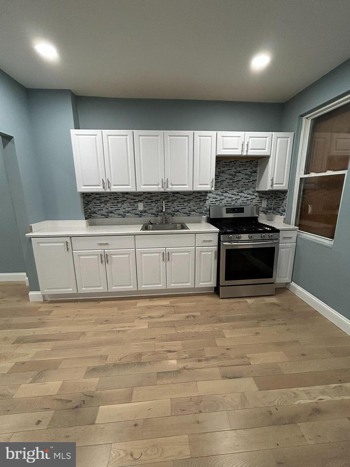 1930 Christian Street Baltimore, MD 21223 - Photo 4 of 20 a kitchen with stainless steel appliances a stove a sink and a microwave