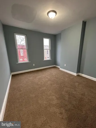 a bedroom with a bed and painting on the wall