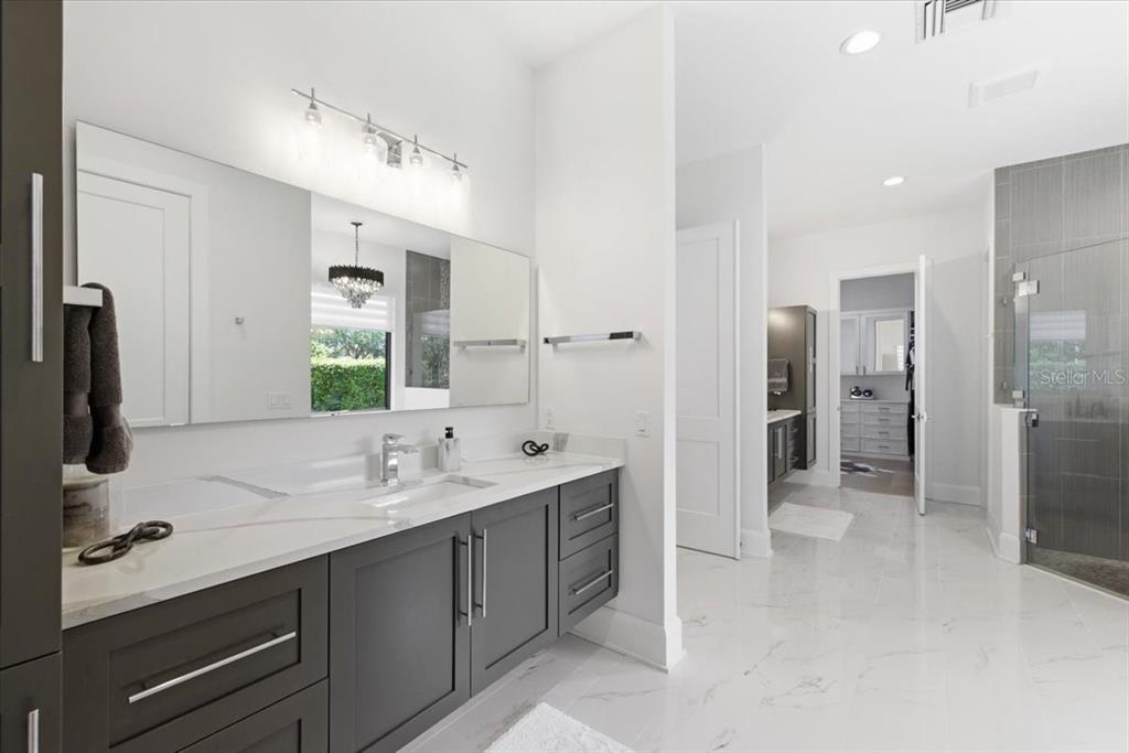 2829 Coastal Range Way Lutz, FL 33559 - Photo 38 of 64 a bathroom with a double vanity sink mirror and shower