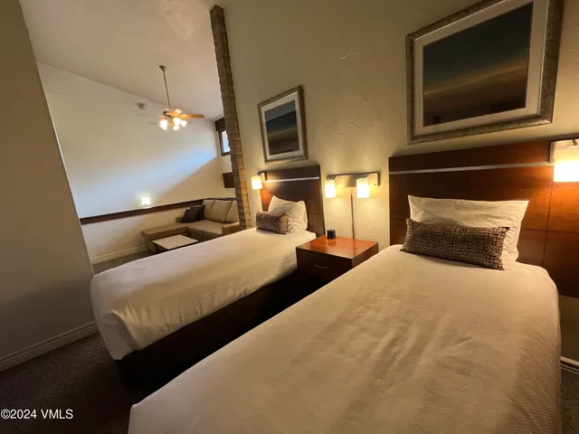 a bedroom with bed tv and window