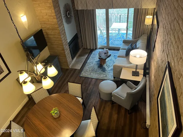 a view of a dining room with furniture and a chandelier