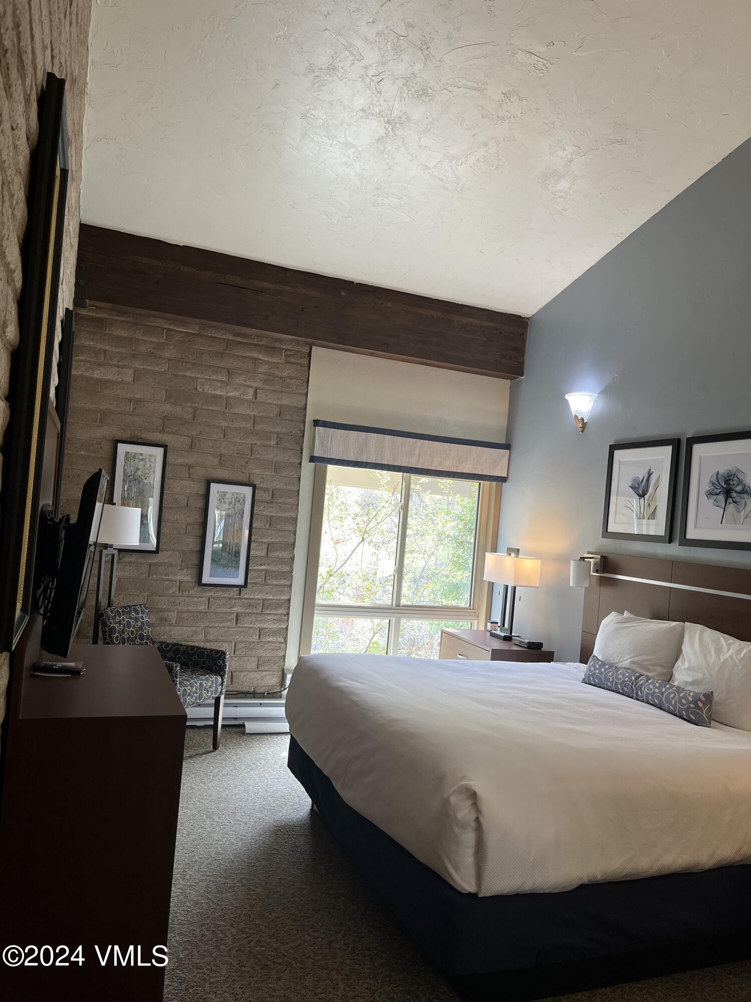 1020 Vail View Drive, Unit 340222 Vail, CO 81657 - Photo 8 of 32 a bedroom with a bed and wooden floor