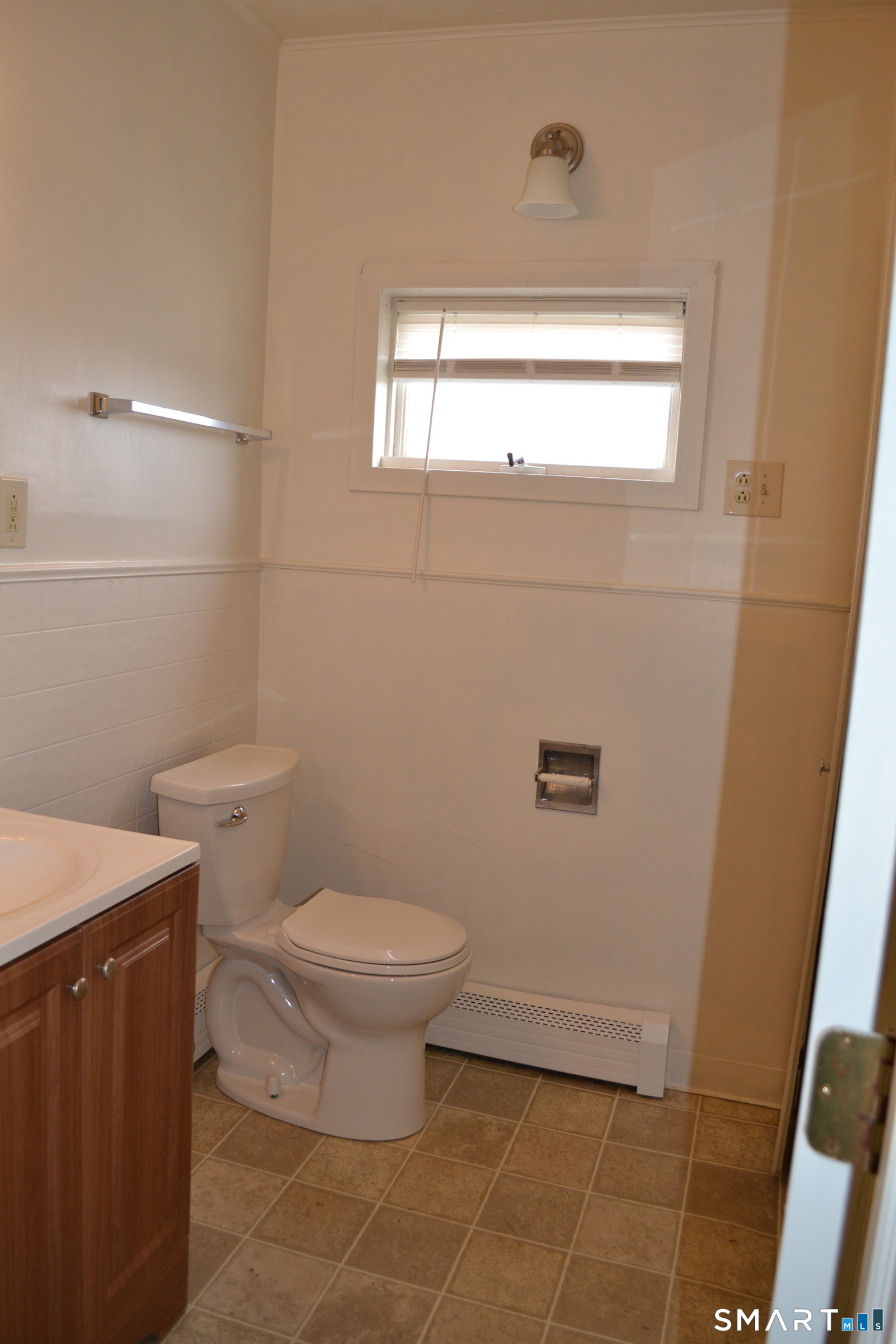 835 Bank Street New London, CT 06320 - Photo 8 of 13 a bathroom with a toilet a sink a window and vanity
