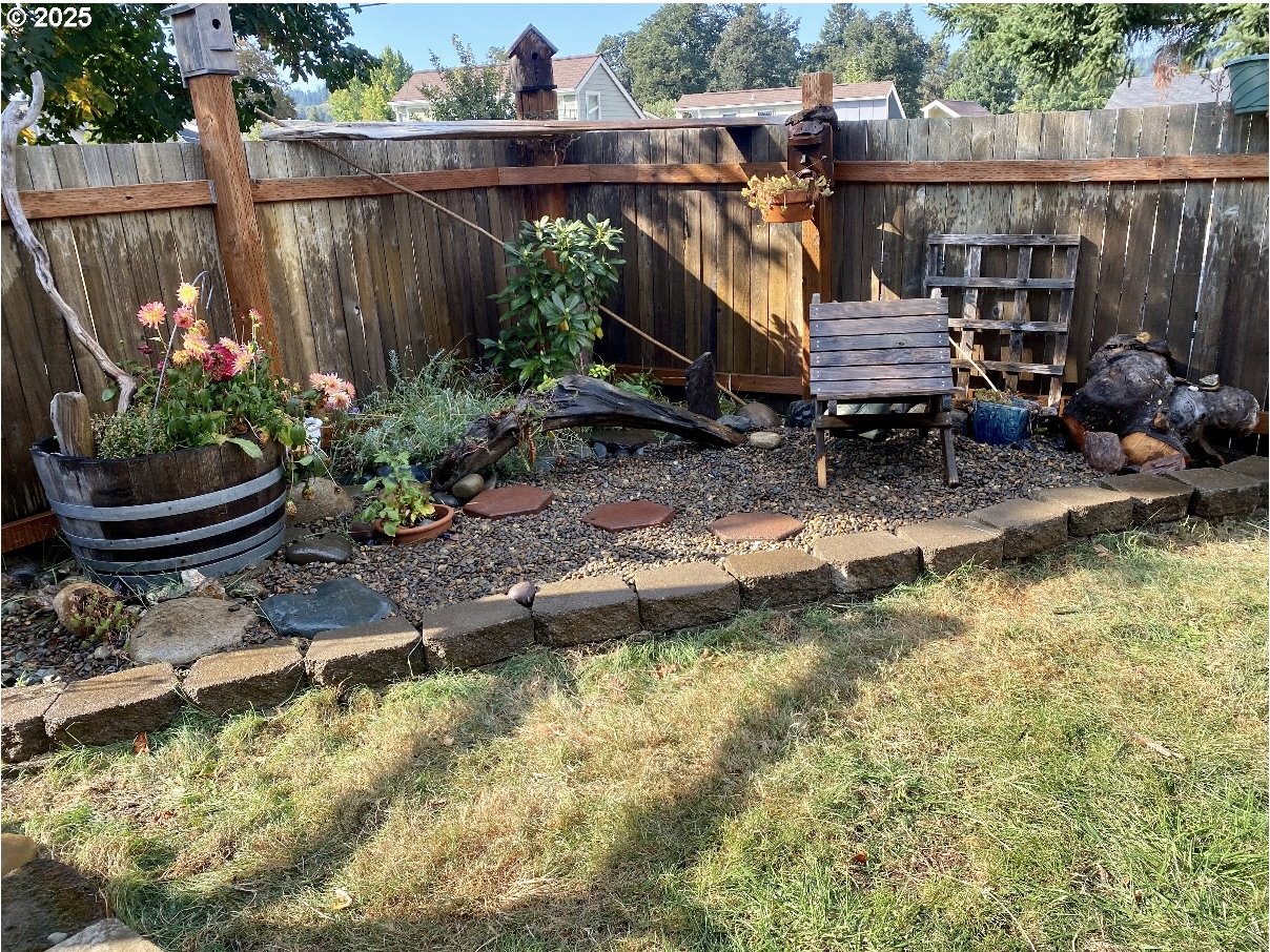 1425 East Madison Avenue Cottage Grove, OR 97424 - Photo 31 of 39 a view of a small house with swimming pool and furniture