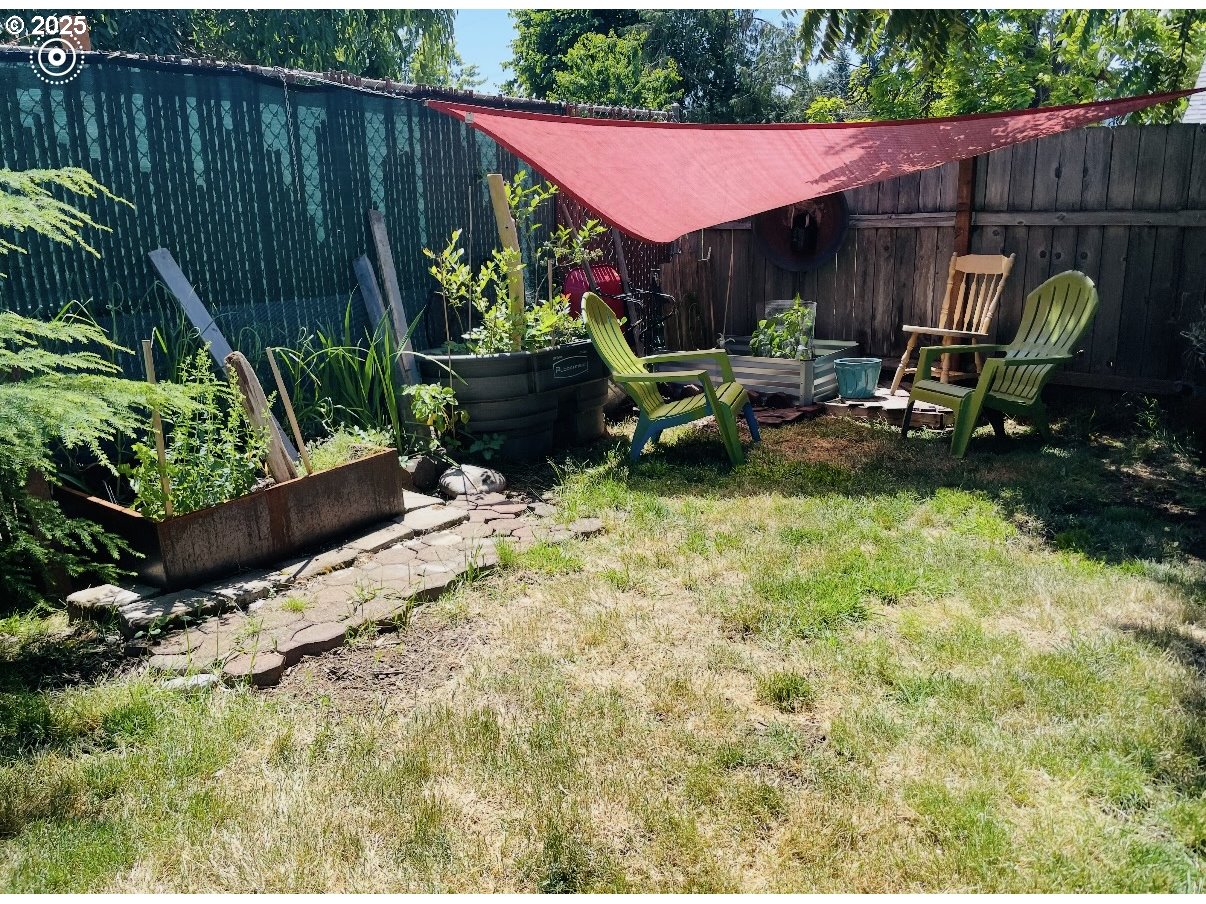 1425 East Madison Avenue Cottage Grove, OR 97424 - Photo 35 of 39 a view of backyard with table and chairs potted plants and wooden fence