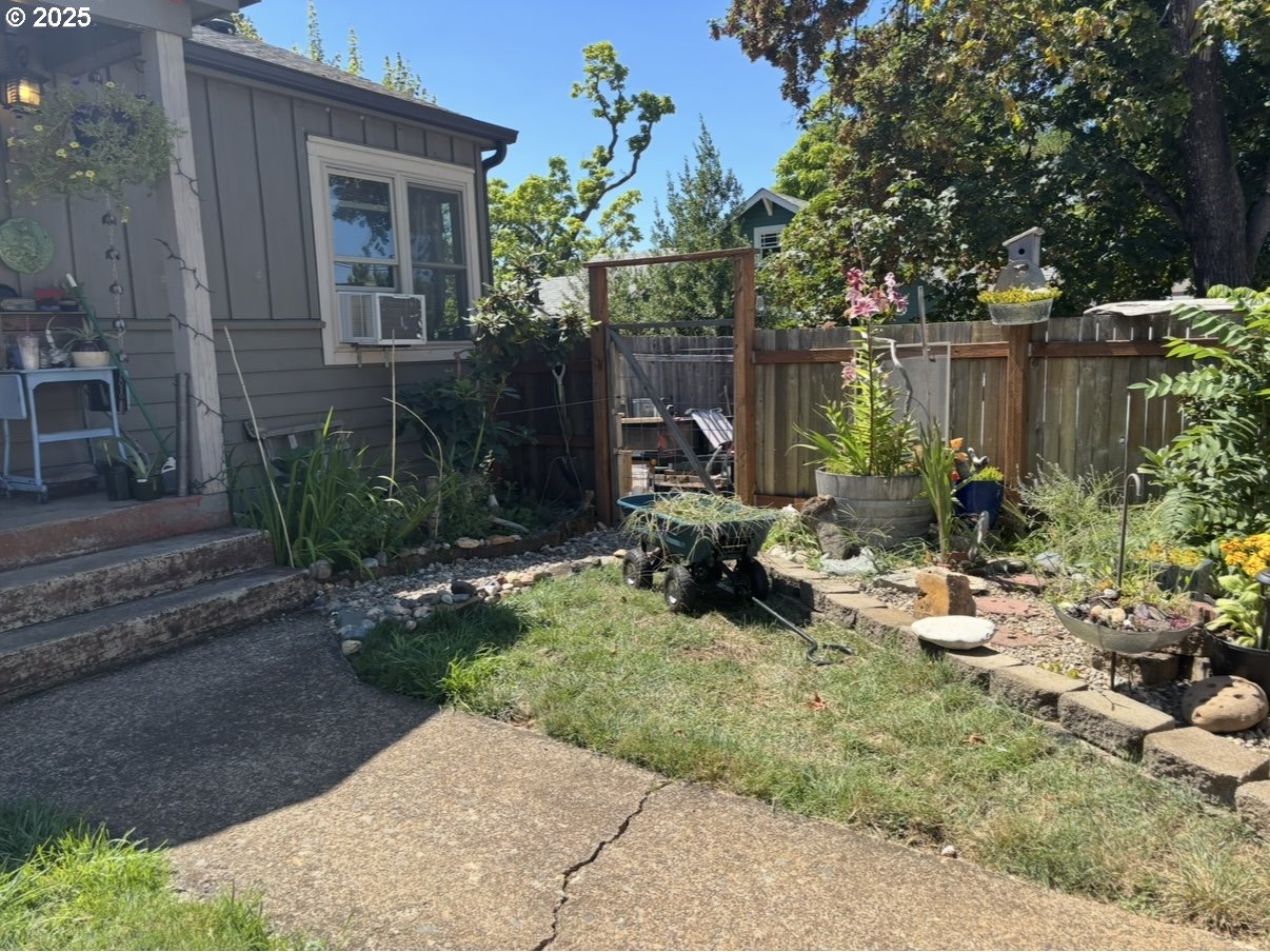 1425 East Madison Avenue Cottage Grove, OR 97424 - Photo 37 of 39 a view of backyard with a table and chairs and potted plants