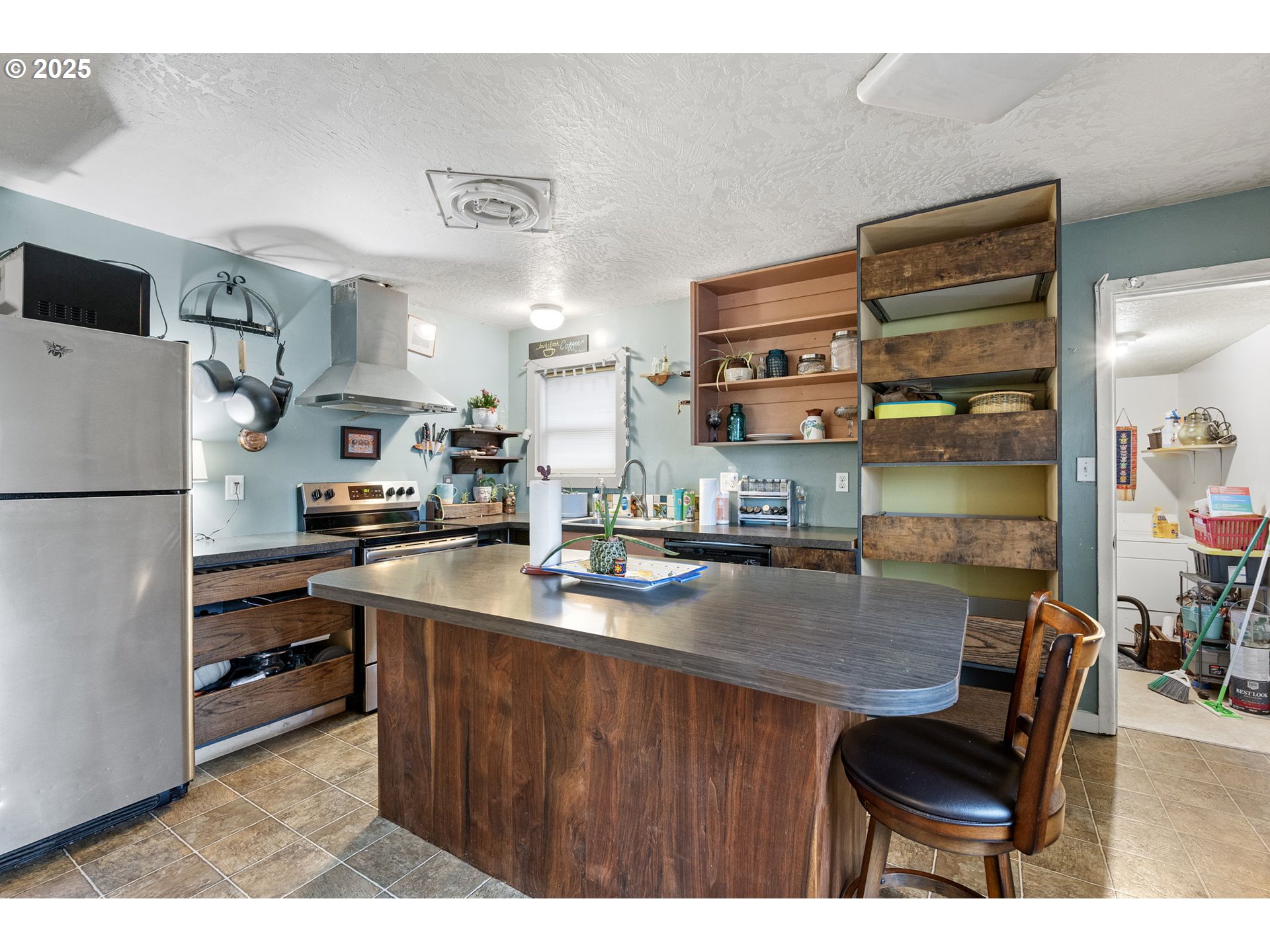 1425 East Madison Avenue Cottage Grove, OR 97424 - Photo 5 of 39 a kitchen with a refrigerator and a table