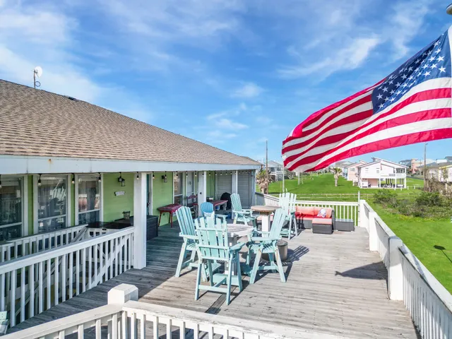 a view of a chairs and table in patio with a backyard